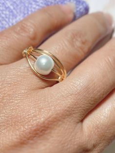 "Beautiful and Unique Gold Wire Wrapped Ring, ideal for an special gift for her,  This ring is made with a 3mm round pearl and wrapped in non tarnish gold wire. This ring is made to order in the size of your choice.  Available in tree different wire colors Gold, rose gold and silver, and you can choose the size and the color of the gemstone. I T E M ~D E T A I L S Materials: Gold Plated Wire, Pearls. Size: See Variations. You can also ask for a different wire color, silver or rose gold tone are Elegant Gold Hand Wrapped Rings, Elegant Hand Wrapped Rings For Anniversary, Elegant Wire Wrapped Promise Ring, Gold Wire Wrapped Pearl Ring Gift, Elegant Wire Wrapped Pearl Ring For Wedding, Elegant Wire Wrapped Pearl Wedding Ring, Elegant White Wire Wrapped Pearl Ring, Minimalist Hand Wrapped Wedding Rings, Elegant Adjustable Wire Wrapped Pearl Ring