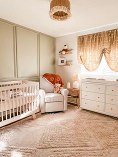 a baby's room with a crib and dressers