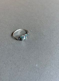 This handmade butterfly ring is made of sterling silver and enamel and was handcrafted in Mexico. A small portion of the black enamel on the ring has cracked off (see pictures). It is size 9. Silver Sterling Enamel Ring With Black Enamel, Silver Sterling Enamel Ring With Black Detail, Silver Sterling Silver Enamel Promise Ring, Vintage Black Enamel Ring, Black Enamel Hallmarked Ring For Gift, Silver Open Enamel Ring For Promise, Silver Enamel Ring As Gift, Silver Sterling Vintage Enamel Ring, Silver Open Ring With Enamel