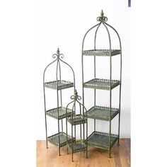 three tiered metal shelfs with ornate designs