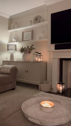 a living room filled with furniture and a flat screen tv mounted above a fire place