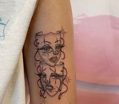 a woman's arm with three faces on it, one is black and the other is white