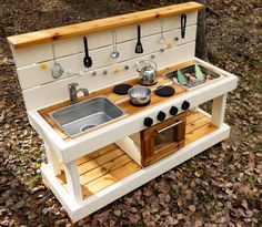 an outdoor play kitchen made out of pallet wood