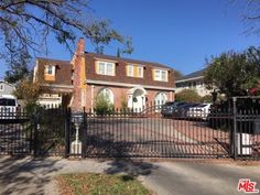 a large house with a gate in front of it