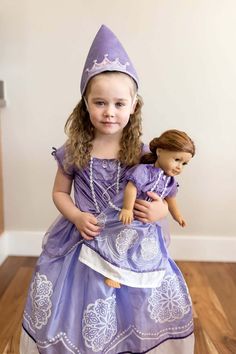 This gorgeous Purple Amulet Princess dress will be a hit with your little one. The comfortable stretchy purple velvet bodice has intricate white trimmings and organza overlaid sleeves, finished off with a tiny bow. The full satin skirt is trimmed with delicate white designs and organza hip drapes. ﻿From Little Adventures, for ages 5-7 Purple Amulet, Princess Dress Up, Tiny Bow, Fabric Accessories, Purple Velvet, Satin Skirt, Traditional Dress, Silk Skirt, White Design