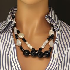 This is part of Chairish’s Fine Jewelry assortment.  This is a lovely, long white Coin Pearl and Black Onyx necklace that is a pleasure to wear.  You can wear it long or double it.  It features white iridescent Coin Pearls, white square Pearls, and two sizes of highly polished smooth Black Onyx.  This necklace is accented with silver spacers and a Sterling Silver nugget clasp.Pearl is the June birthstone, but don't wait till then to add this lovely necklace to your collection. Pearls are Mother Black Onyx Necklace, Coin Pearls, Onyx Necklace, Black Onyx Stone, White Square, June Birthstone, Handcrafted Necklace, Lovely Necklace, Onyx Stone