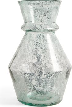 a glass vase sitting on top of a white table