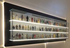 a lighted display case filled with star wars figurines and action figures on the wall