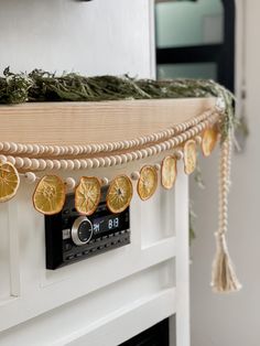 orange slices are hanging from a string on the mantle