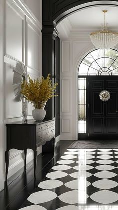 a black and white checkered floor in an elegant entryway with chandelier