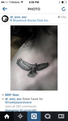 the back of a woman's chest with an eagle tattoo on it