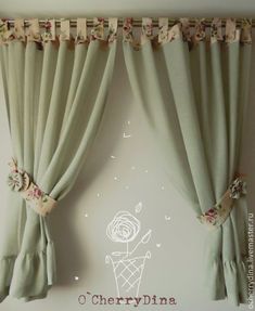 the curtains are hanging on the wall near the window sill, and there is an ice cream cone with flowers in it