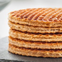 a stack of waffles sitting on top of a table next to each other