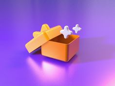 an orange box with two small white stars on the lid and one is open, sitting on a purple surface