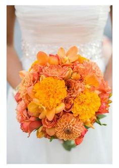 the bride's bouquet was made up of orange and yellow flowers