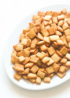 a white plate topped with cut up cubes of food on top of a table