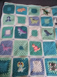 a crocheted blanket with animals on it