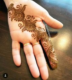 the hand is decorated with henna designs on it