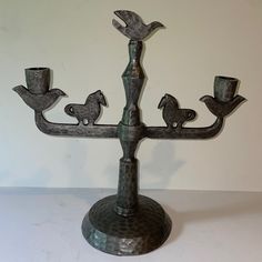 a metal candelabra with birds on it