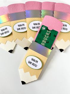 several pieces of paper with labels on them sitting next to each other in the shape of a rainbow