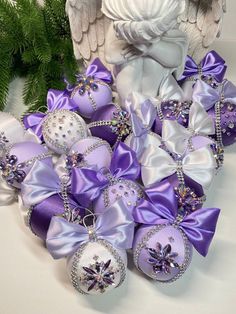 purple and white ornaments with angel wings on them