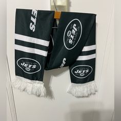 two new york jets scarfs hanging on the door