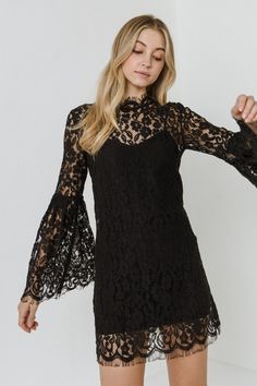 When it comes to lace, we can't get enough. This Bell Sleeve Lace Dress is made from a luxurious and timeless fabric with a mini silhouette. The bell sleeves and scalloped lace detail add a feminine touch to this piece. Wear this dress to an evening wedding or to any occasion that calls for a chic and feminine style. Lace fabric Optional camisole dress Scalloped lace edge Bell sleeves with pleated detail Hand wash cold Do not bleach Do not tumble dry Iron low Shell: 100% Polyester Lining: 100% P Short Dresses For Women, Short Long Dresses, Sleeve Lace Dress, Lace Dress With Sleeves, Camisole Dress, Evening Wedding, Lace Dress Black, Long Black Dress, Womens Black Dress