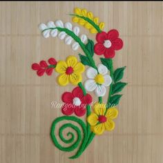 a close up of a flower on a wooden surface with a spiral design in the middle