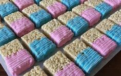 there are many cookies that have blue and pink frosting on top of them,