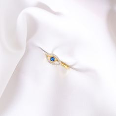 Your Solid Gold Sapphire Eye Band Ring is stylish, dainty and pretty ideal for everyday use. Details of solid gold handmade Good Luck Eye Ring are very eye-catching. It is a great gift for your loved ones. This jewelry will be an indispensable piece of yours. This meaningful Diamond Devil Eye Ring with high quality handwork will be a legacy you can leave to your family its.  * Sapphire Evil Eye Ring Details * Material / Gold Kt : This elegant ring is made of 14k and 18k Solid Gold * Available Go Gold Rings With Diamond Eyes For Promise, Gold Promise Ring With Diamond Eyes, Elegant Diamond Ring With Diamond Eyes For Promise, Yellow Gold Sapphire Ring With Cubic Zirconia, Elegant Gold Rings With Diamond Eyes, Fine Jewelry Wedding Ring With Diamond Eyes, Gold Rings With Diamond Eyes For Anniversary, Fine Jewelry Diamond Eyes Rings For Gifts, White Gold Rings With Diamond Eyes As Gift