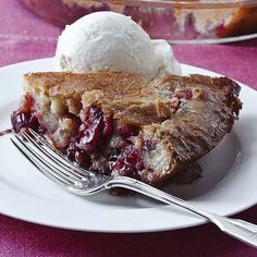 a piece of pie on a white plate with a fork and scoop of ice cream