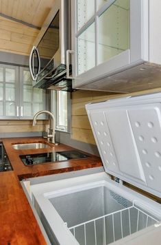 a kitchen area with sink, stove and cabinets in the back drop off cabinetry