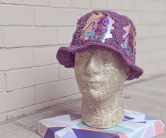 a crocheted hat sitting on top of a mannequin head