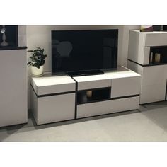 a white entertainment center with black accents