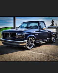 a blue pickup truck parked in a parking lot