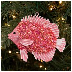 a pink fish ornament hanging from a christmas tree