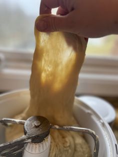 a person is using a hand mixer to mix food