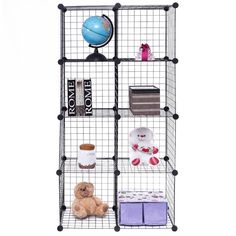 the four tiered shelving unit is made out of wire and holds various items