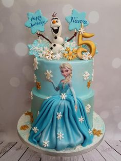 a frozen princess cake is decorated with snowflakes