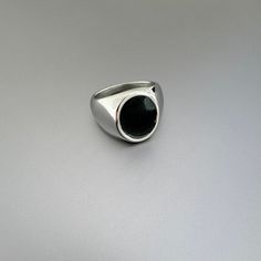 Mens Jewelry | Stainless Steel Signet Pinky Ring with Black Oval Detail. Ring: Polished Stainless Steel  Oval: Acrylic Oval Width 0.65 inches / (17mm) Weight 0.3 oz CARE: Stainless Steel:   Use a polishing cloth to gently wipe this item clean, then remove any remaining tarnish with mildly diluted soap. Rinse with warm water and dry thoroughly.  STORAGE: When not in use, store your item in the provided complimentary jewelry pouch. We gladly accept returns and exchanges if the item is not a perfec Modern Black Round Band Ring, Black Signet Ring With Polished Finish, Classic Black Enamel Ring, Modern Black Dome Ring, Black Polished Round Band Rings, Modern Black Oval Signet Ring, Minimalist Stainless Steel Signet Ring, Modern Black Round Rings, Modern Black Dome Ring As A Gift