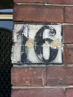 a brick wall with the number sixty painted on it