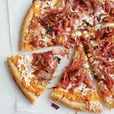 a sliced pizza sitting on top of a white paper