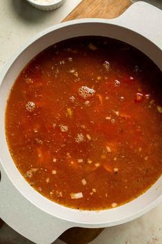 a white bowl filled with soup on top of a table