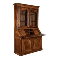 an old fashioned wooden desk with drawers and cupboards on the top, in front of a white background