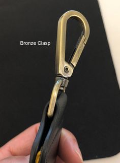 a person holding a pair of scissors in their right hand and the other end of the handle