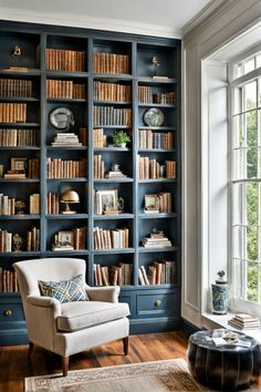 Home library with blue bookshelves and white walls and ceiling Two Story Bookshelves, Home Library Diy Built In Bookcase, Home Library Designs, Built In Shelves With Windows, Home Library Built In Bookshelves, Bookcase Between Windows, Wall Of Built In Bookshelves, Vaulted Ceiling Bookshelves, Ceiling To Floor Bookshelves