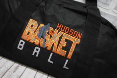 WHY THIS ONE IS SPECIAL: With a orange BASKETball design, this bag is ready to hold all your stuff whether for after school practice, competitions or even a weekend at grandma's! Add a name for a super personalized bag. The HMTO Guarantee: Hand Made To Order means this product is not premade, so this item will be unique and hand crafted just for you! Current Production Times. THREE GREAT STYLES: TOTE bag measures 12x18"with a zippered top. SMALL barrel duffle bag measures 18”x10”x10”, with a side zippered pocket. LARGE square bottom duffle bag measures 24”x12 x11”, with a front zippered pocket. WHY YOU NEED IT: With a design you won’t find anywhere else, these duffle bags show off your favorite activity, while keeping all your gear handy and protected. Both sizes are roomy and fit shoes, c Black School Spirit Bag For College, Customizable School Spirit Bag For Everyday, Customizable School Spirit Bags For Everyday Use, Orange Basketball, Basketball Bag, Favorite Activity, Personalized Basketball, Basketball Design, Duffle Bags