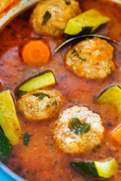 meatballs and vegetables are in a stew with carrots, zucchini, and parsley