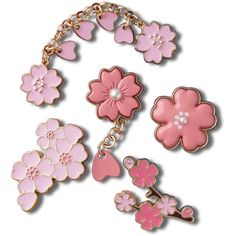 pink and white flowers are attached to a gold - toned chain bracelet with matching charms