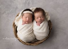 two newborn babies are curled up in blankets